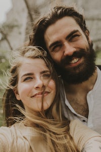 a man and woman are taking a selfie together